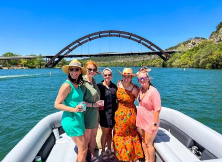 Five women on a boat, including a redhead