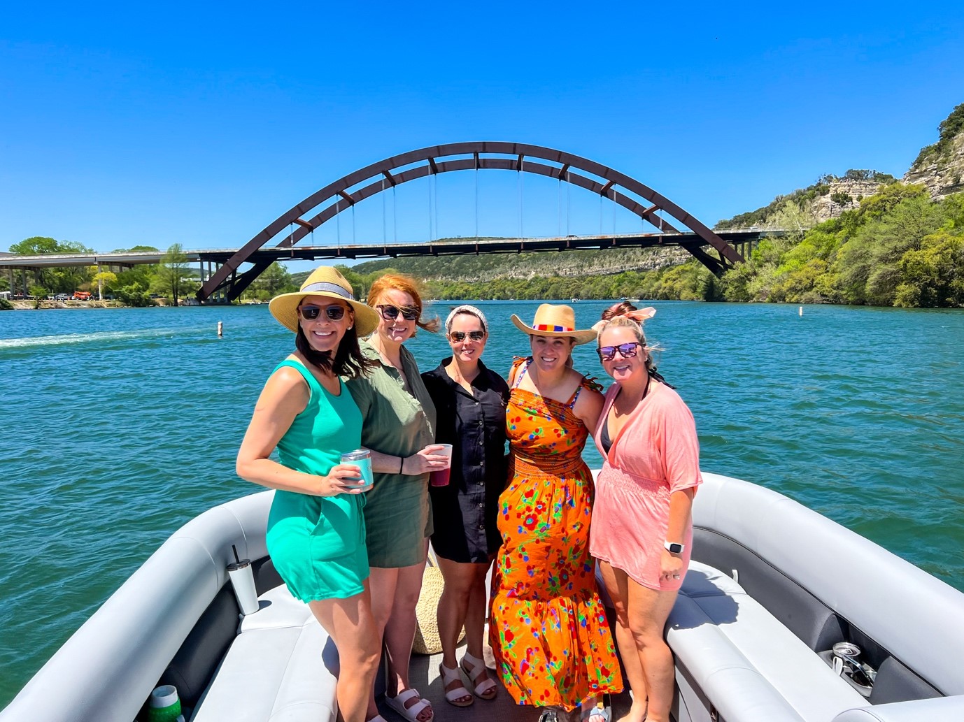 Five women on a boat, including a redhead