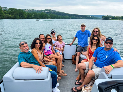 A family taking a boat tour on Lake Austin.