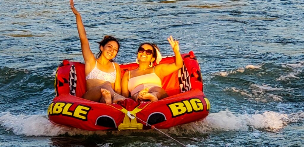 Group of friends enjoying an exhilarating water tubing experience with Wake Riderz on Lake Austin.