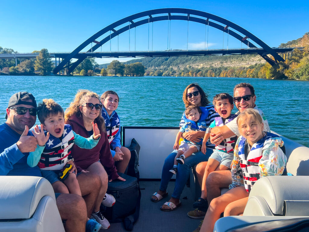 Wake Riderz pontoon under Pennybacker Bridge on Lake Austin TX during sunset