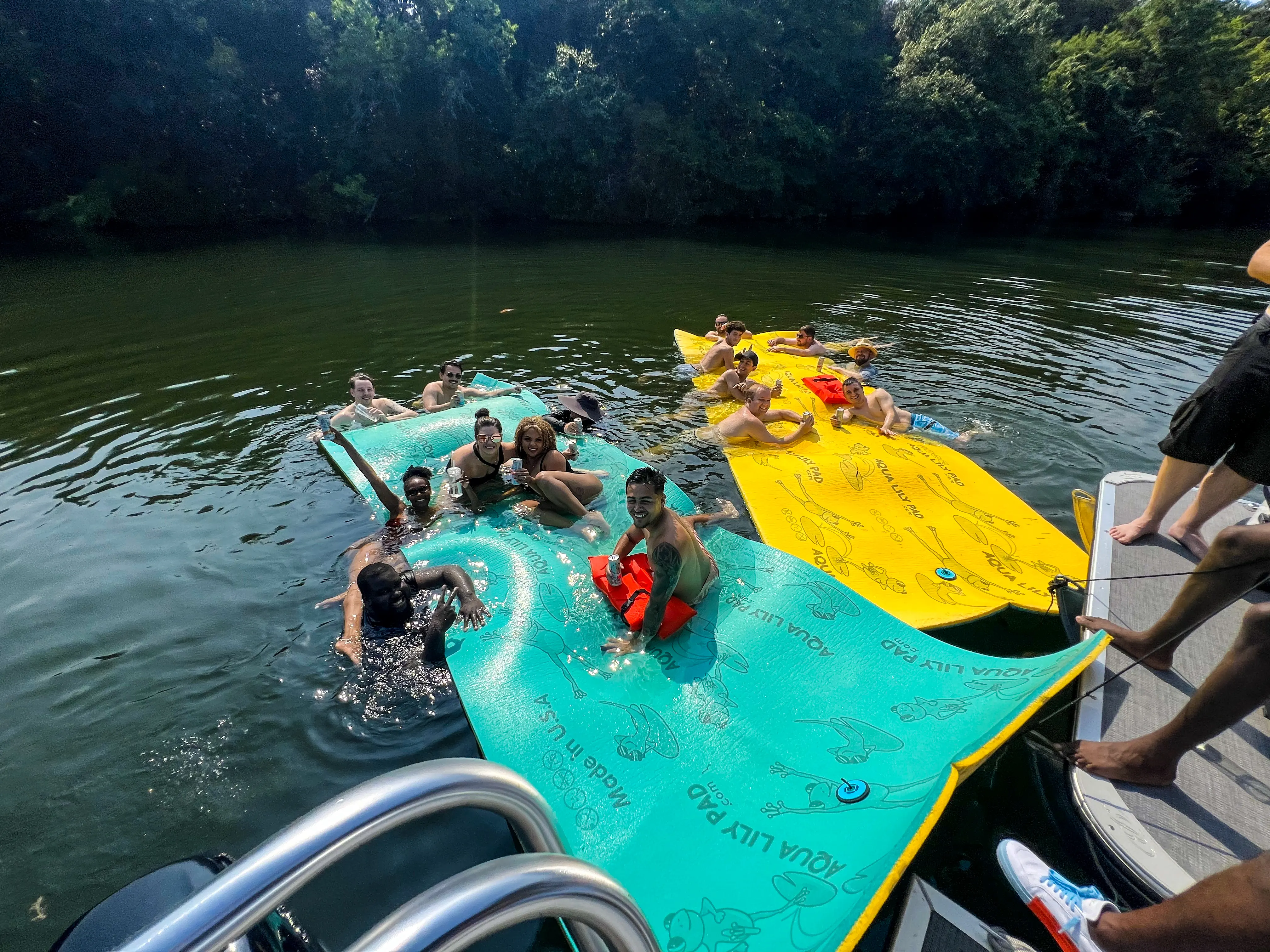A corporate event enjoying the Aqua Lily Pad with Wake Riderz's Corporate Boat Rental