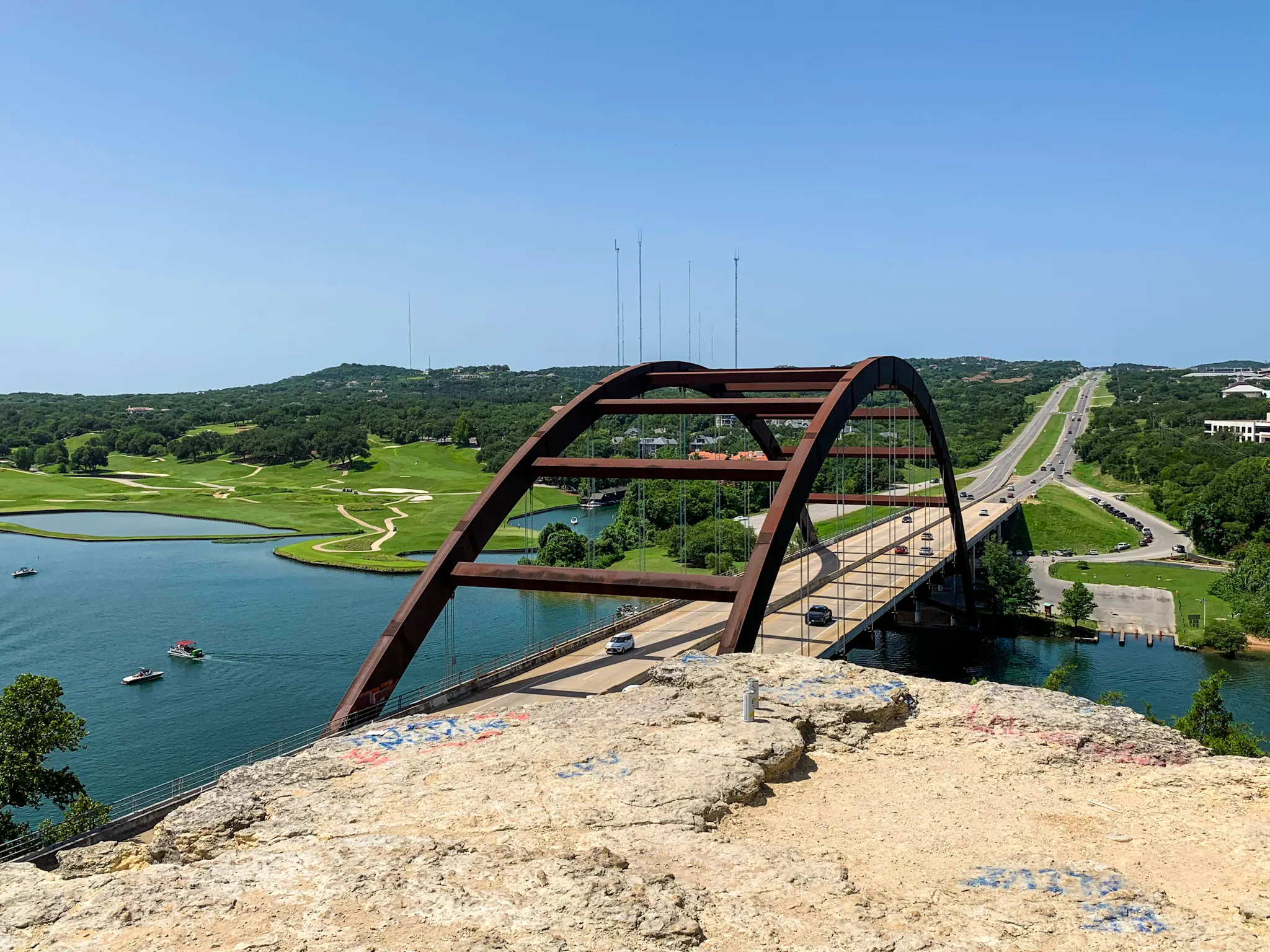 Wake Riderz boat cruising beneath Pennybacker Bridge on Lake Austin in Austin, Texas