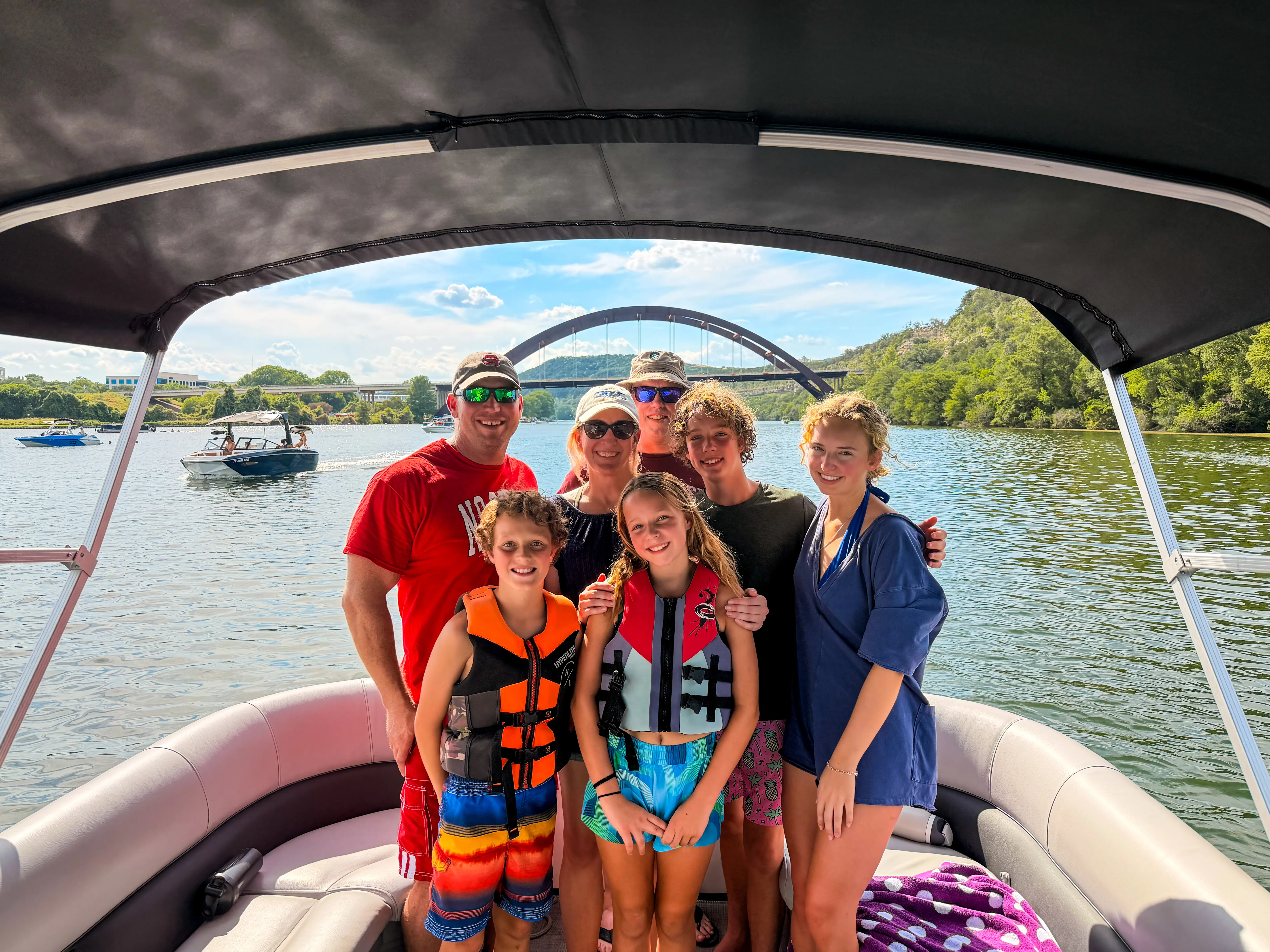 Family enjoying a private captained pontoon boat rental on Lake Austin