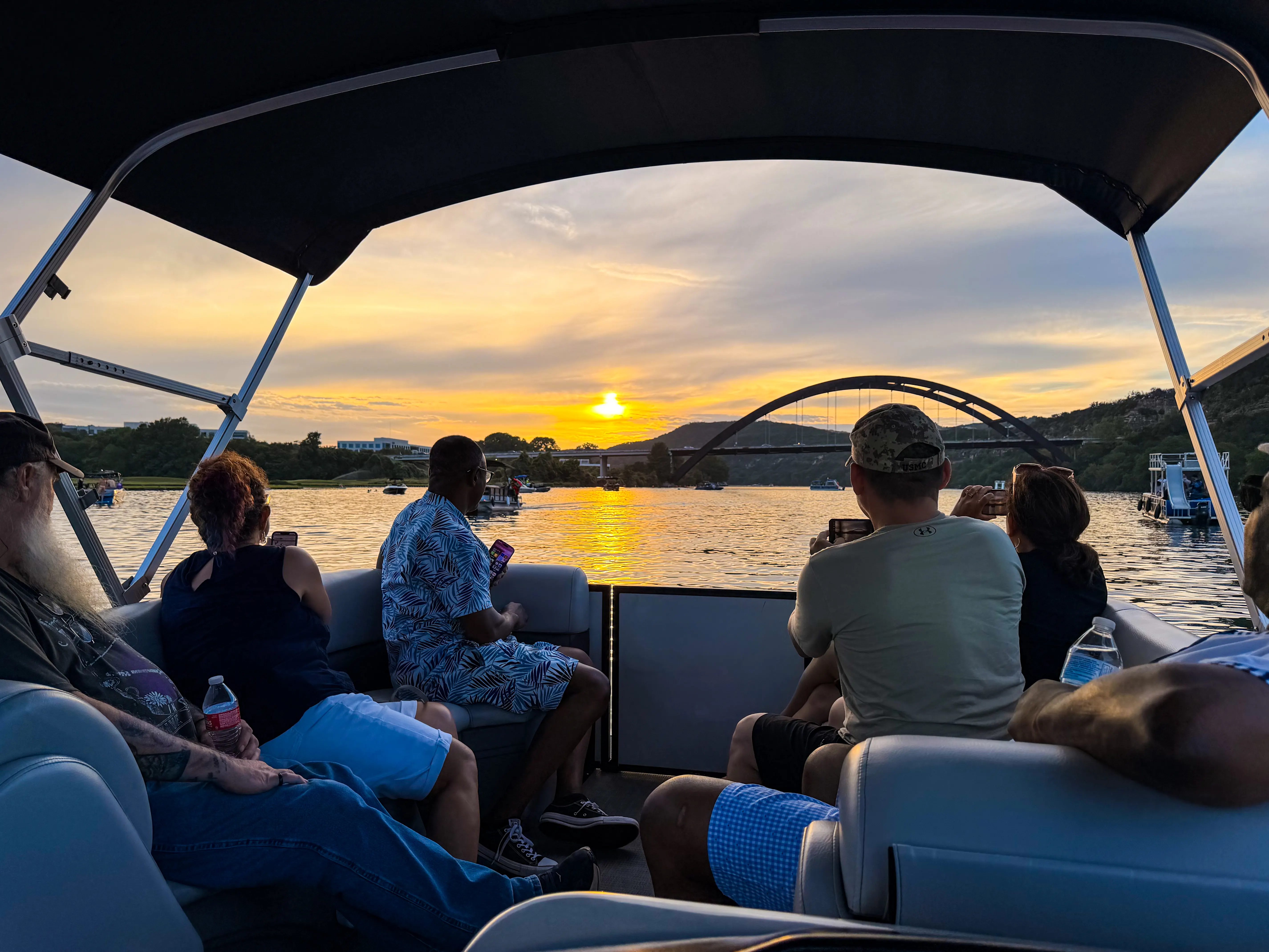 Passengers relaxing aboard a private captained sunset cruise on Lake Austin
