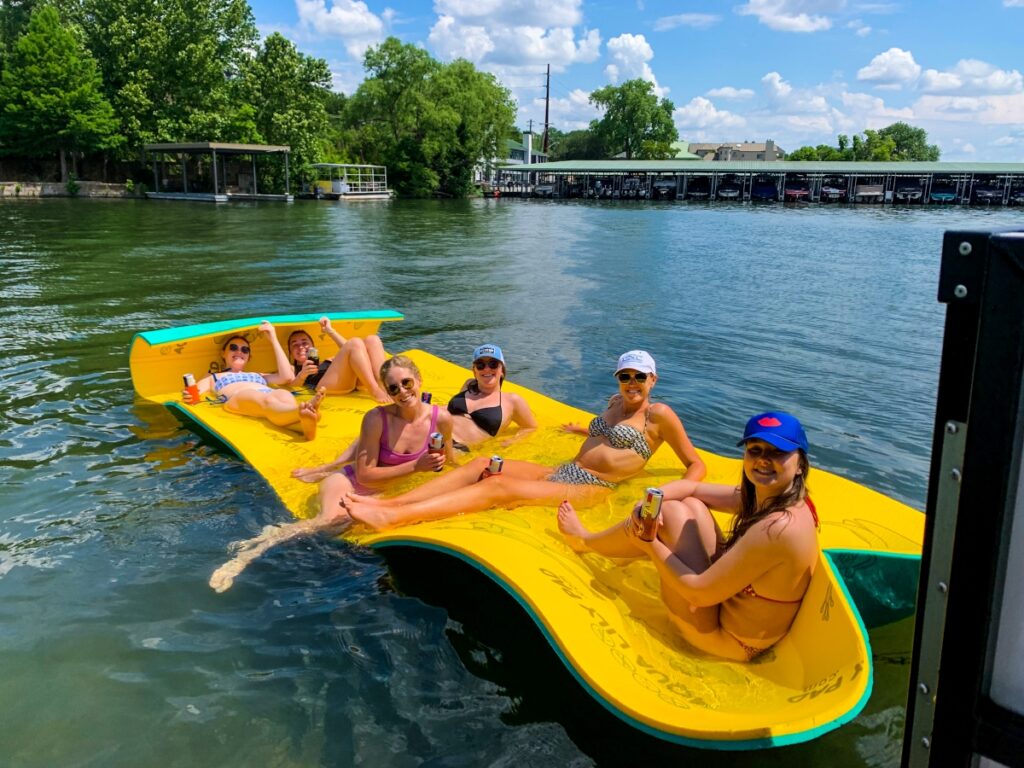 Happy customers on Aqua Lily Pad during Lake Austin pontoon rental
