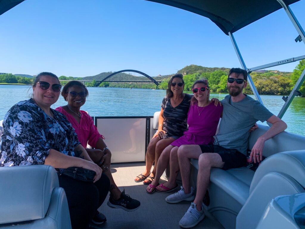 Lake Austin pontoon boat rental passing 360 bridge with group of friends
