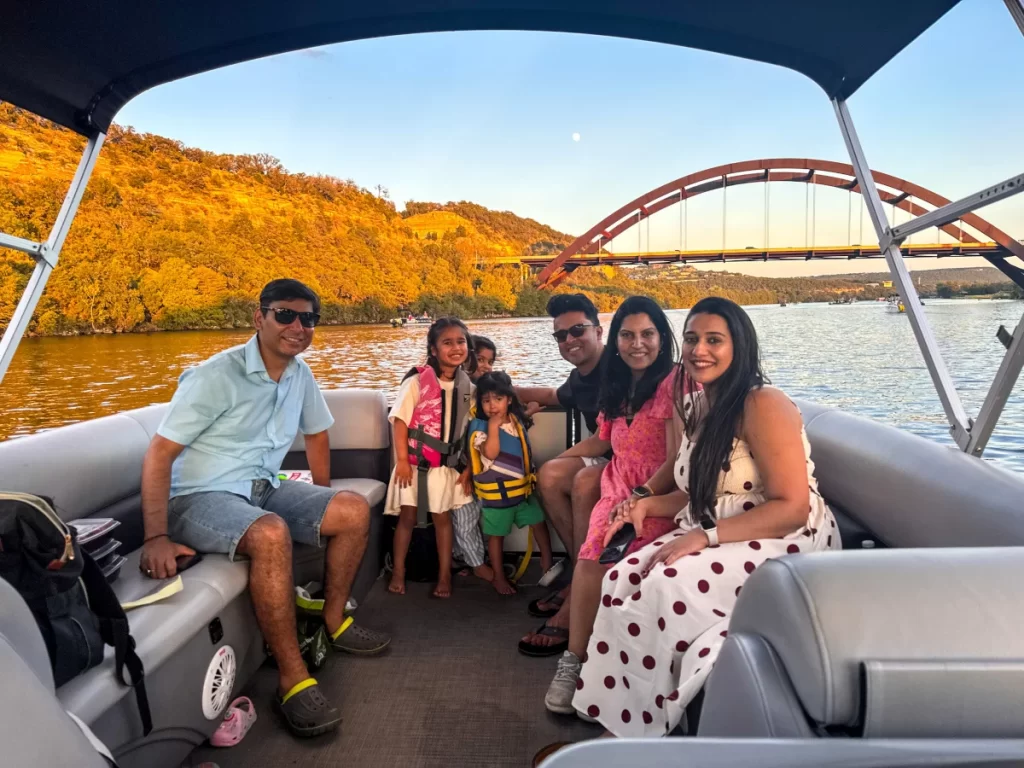 Family enjoying a captained pontoon boat tour near Pennybacker Bridge on Lake Austin