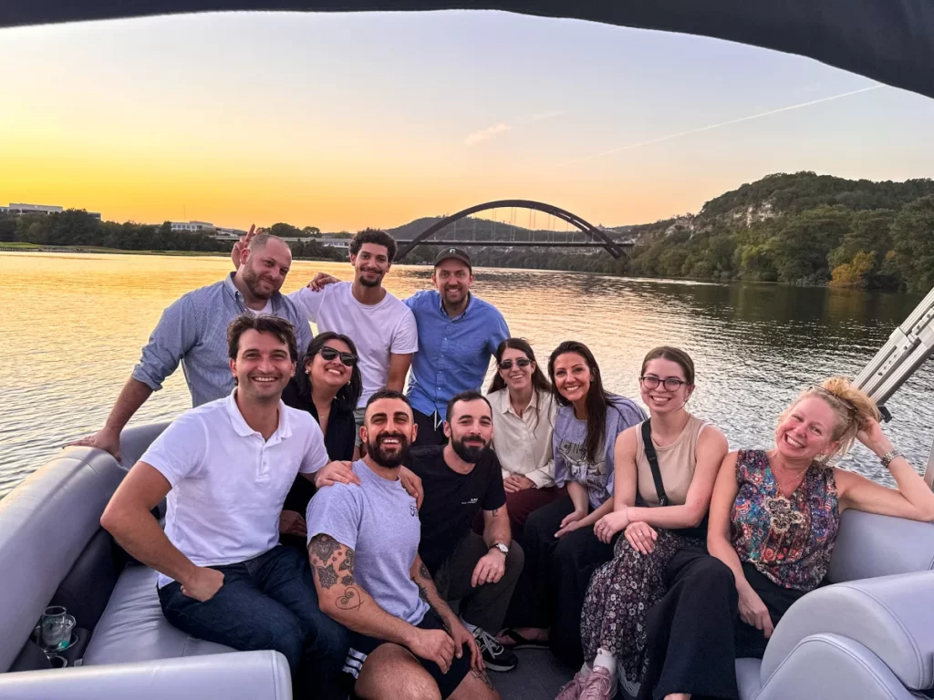 Group enjoying a private captained boat rental at sunset on Lake Austin under Pennybacker Bridge