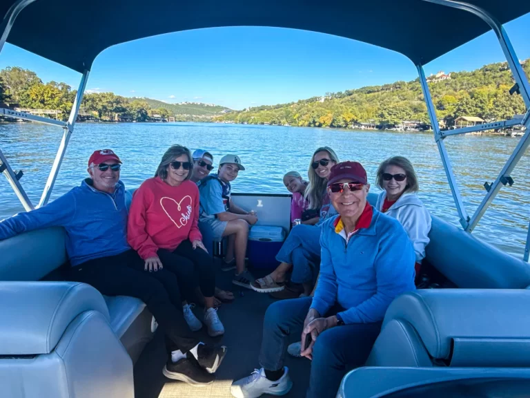 Family enjoying a relaxing captained pontoon cruise on a sunny Lake Austin afternoon