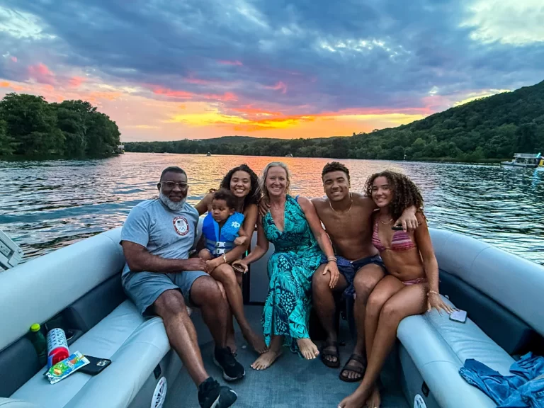 Family enjoying a beautiful Lake Austin sunset during a captained pontoon boat cruise