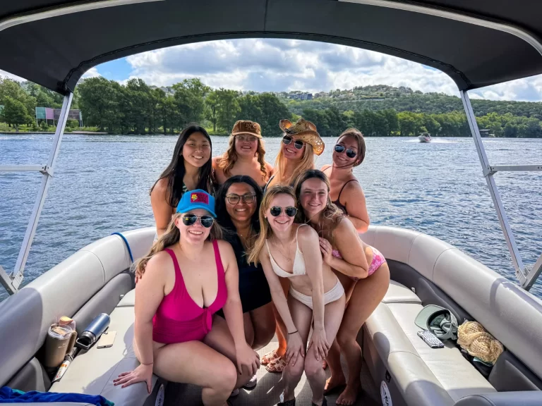 Group of friends enjoying a sunny girls’ day out on a captained pontoon boat on Lake Austin