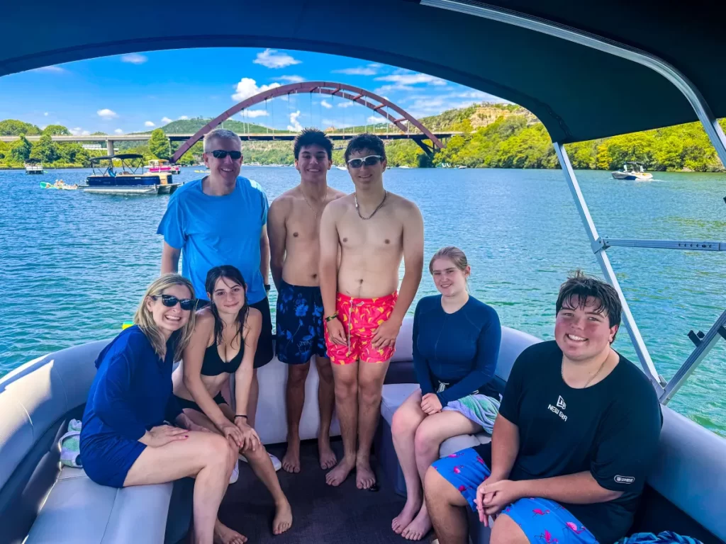 Private pontoon boat rental on Lake Austin with family under Pennybacker Bridge